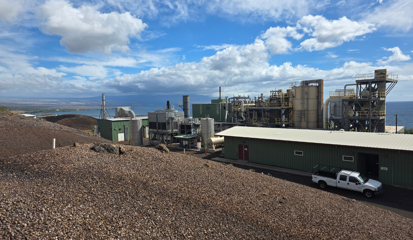 AgEnergy Hawai‘i biochar plant overlooking the Kawaihae coastline with reactors, stacks, and storage tanks